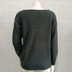 Detailed view of the dark green knitted sweater back, showcasing fine texture and cuffs.
