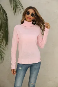 Close-up view of the cozy pink turtleneck knit sweater, featuring soft fabric and long sleeves.