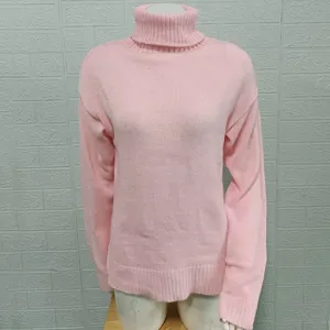 Pink turtleneck sweater detail showing soft knit texture, long sleeves and ribbed collar.