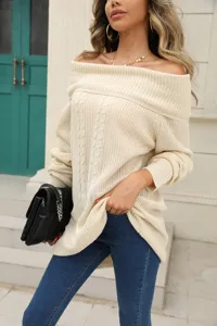 Detailed view of women's off-shoulder knitted sweater, showcasing fabric texture.