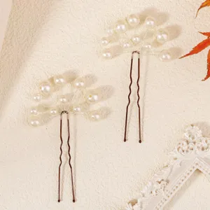 Handcrafted pearl U-shaped hair pins, elegant bridal hair accessories and bun styling details.