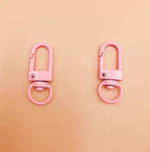 Pink metal swivel lobster clasps for keychains, durable zinc alloy hardware accessories.