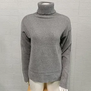 Detail view of grey turtleneck knit sweater, ribbed collar and hem, classic basic style.