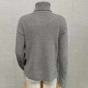 Back view of a solid color turtleneck long sleeve knit sweater in classic style.