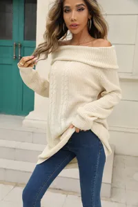 Detailed view of a stylish off-shoulder knitted sweater with cable knit texture in beige color.