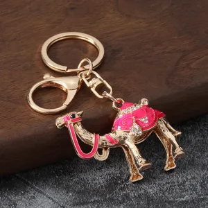 Detailed view of a metal camel keychain with pink enamel and rhinestones, alloy bag pendant.