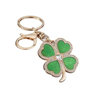 Elegant rhinestone four leaf clover keychain golden metal bag charm and car key pendant for women.
