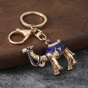Metal alloy camel keychain bag charm with blue enamel and sparkling rhinestones for car keys.