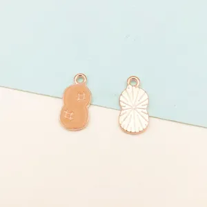 Peanut charm detail shot showcasing enamel texture and metal craftsmanship for DIY jewelry.