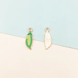 Closeup detail of metal enamel pea pod and leaf charms for DIY bracelets and keychains.