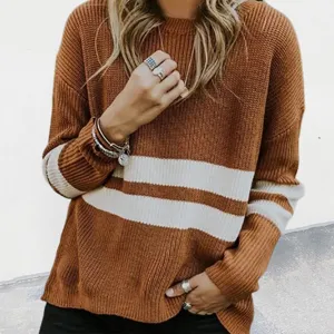 Close-up detail of women's cozy knit sweater featuring contrast stripes and soft texture.