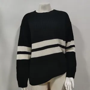 Close-up detail of women's black and white striped knit sweater, cozy autumn winter apparel.