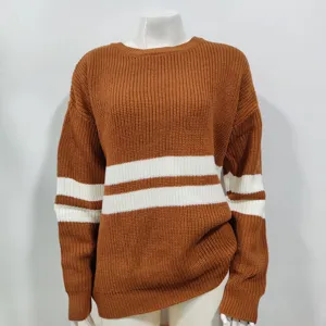 Close-up view of brown knit fabric with white stripes, showing soft texture and winter cozy details.