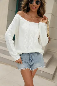 Off-the-shoulder cable knit sweater detail showing exquisite texture and elegant style.