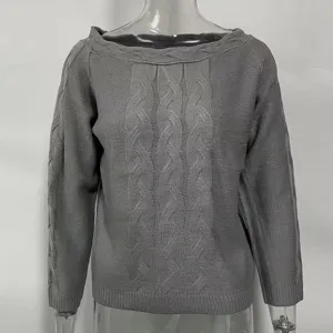 Grey cable knit sweater detail showing textured pattern and boat neckline design.