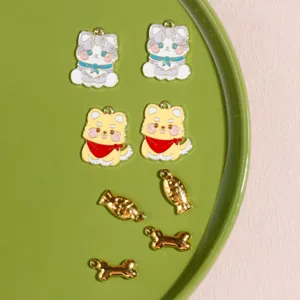 Closeup detail of cute cat dog fish bone alloy charms for DIY jewelry making and keychains
