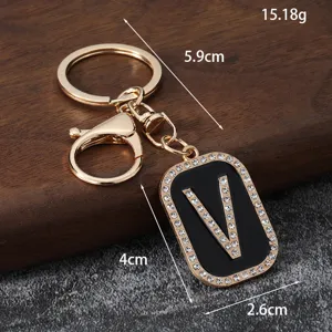 Rhinestone letter V metal keychain, luxury bag pendant and car key accessory for women.