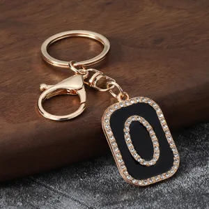 Gold metal rhinestone letter O keychain charm for car keys, bags, and stylish accessories.