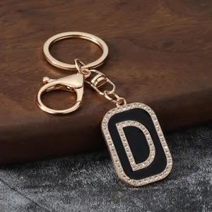 Close-up of sparkling rhinestone letter D metal keychain pendant accessory detail shot