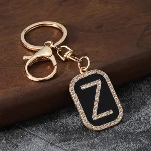 Detailed shot of gold metal letter Z rhinestone keychain pendant with black enamel finish.