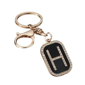 Gold metal rhinestone letter H keychain, stylish black pendant car key ring backpack accessory.