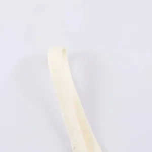 Beige slip dress strap detail close-up, showing fine stitching and soft fabric.