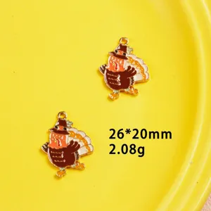 Close-up detail shot of Thanksgiving turkey enamel metal charms for DIY crafting.