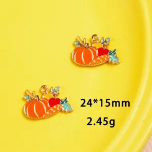 Close-up detail of autumn Thanksgiving pumpkin and carrot enamel alloy DIY jewelry pendants.