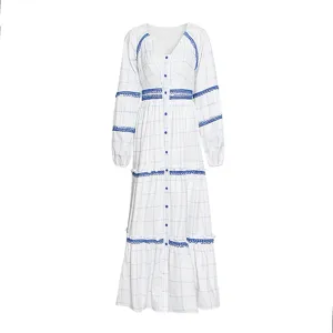 Vestido largo blanco de cuadros con detalles de encaje azul y mangas largas estilizadas.