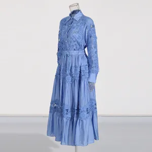 Vista detallada del conjunto de camisa y falda caladas con bordados de encaje azul de gran elegancia.