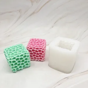 Detailed view of square honeycomb cube silicone mold and handmade candles for DIY craft projects.