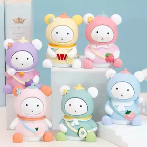 Cute cartoon bear figurines with colorful backpacks and fruit accessories, perfect desktop decor.