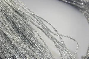 Close-up detail of shiny silver tinsel cord, perfect for craft and DIY accessories.