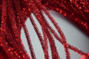 Detailed macro view of red metallic tinsel stems, perfect craft material for DIY decoration.