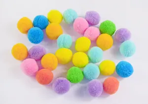 Colorful fluffy pom pom balls detail view, perfect for craft DIY and interactive cat toys.