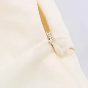 Close-up detail of smooth hidden zipper and fine fabric texture on elegant dress.