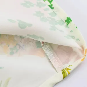 Close-up of floral fabric print and fine hem stitching details for women summer dress.