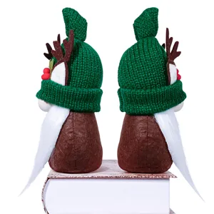 Christmas faceless gnome doll with green knit hat and reindeer antlers for holiday desktop decor.