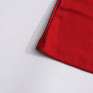 Red dress fabric detail close-up showcasing fine stitching and smooth solid texture.