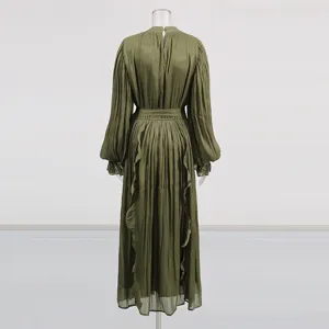 Vue arrière d'une robe longue vert olive à manches longues, tissu brillant et liens à la taille.
