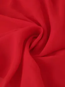 Détail de tissu mousseline rouge, texture lisse et légère, tombé élégant pour robe d'été.