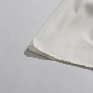 Fine fabric detail and neat stitching close-up, premium texture for clothing apparel.