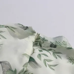 Close-up detail of a light green sparrow and leaf pattern summer vintage women's dress collar.