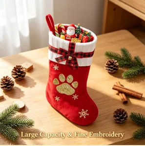 Close-up detail of large red Christmas stocking with plush cuff, bow, and glitter paw print.