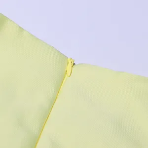 Yellow dress fabric detail, close-up view of zipper, fine texture, solid color clothing.