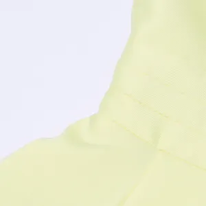 Detail shot of the elegant vintage yellow dress featuring fine pleated texture and royal style.