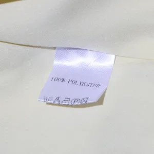 Close-up detail shot of the soft fabric and interior wash label showing material info.