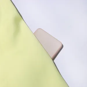 Yellow dress fabric texture detail shot, featuring smooth woven material and minimalist aesthetic.