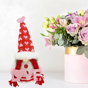 Valentine's Day plush gnome doll detail showcasing red heart hat and pink glitter love sign ornament.