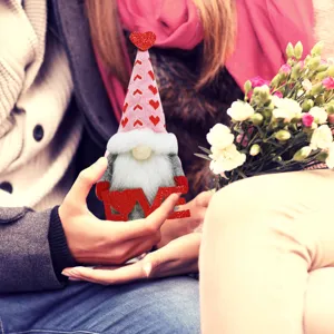 Valentine's Day faceless gnome doll holding love sign, romantic couple scene holiday decor.